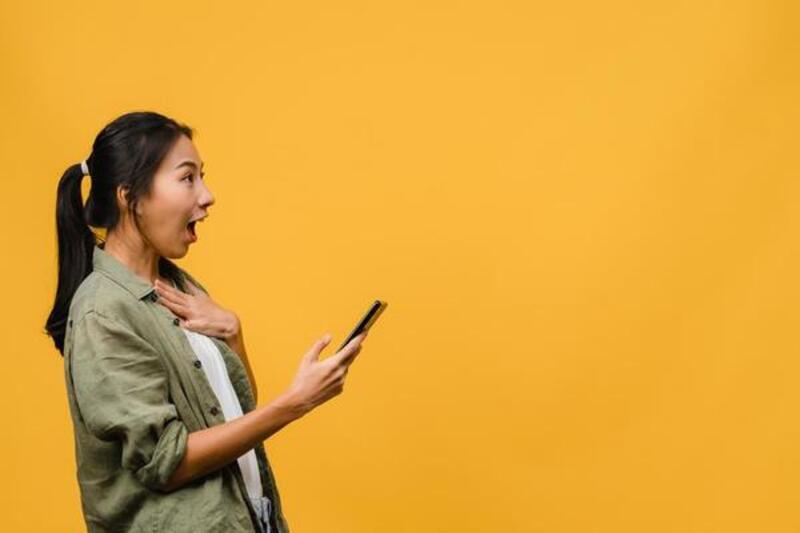 surprised woman with phone in hand